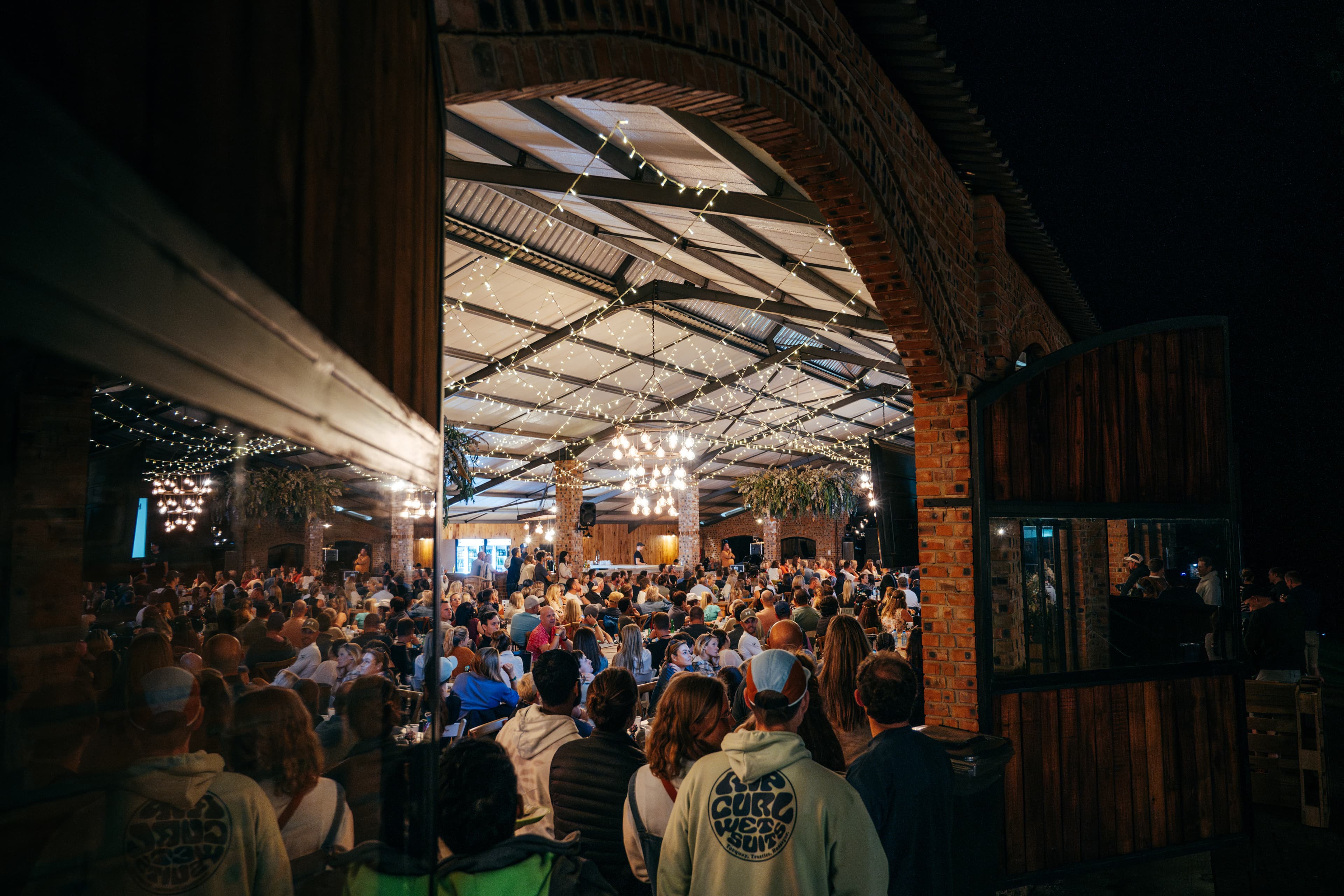 Evening event at barn venue with crowd