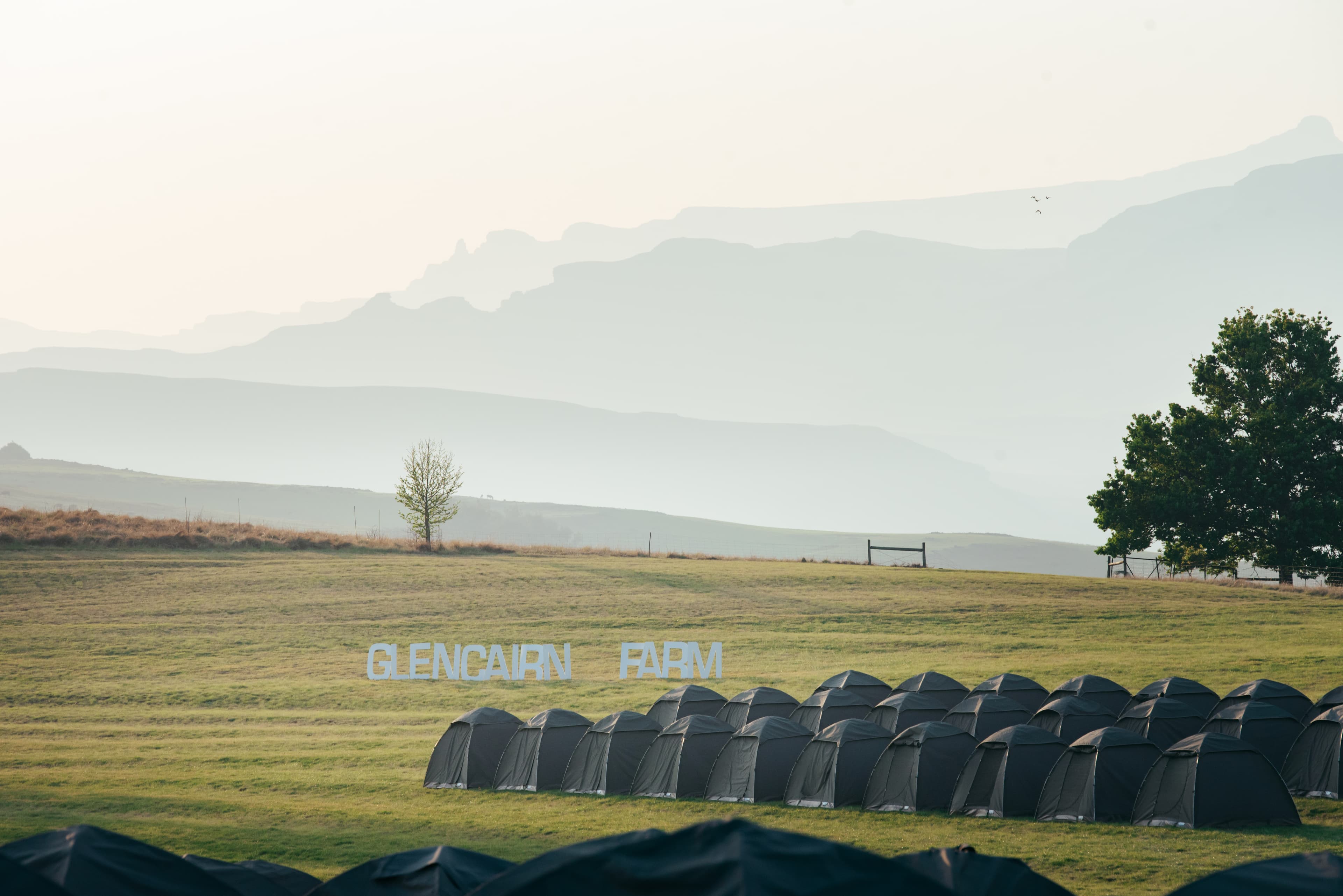 Glencairn Farm sign with Drakensberg in haze