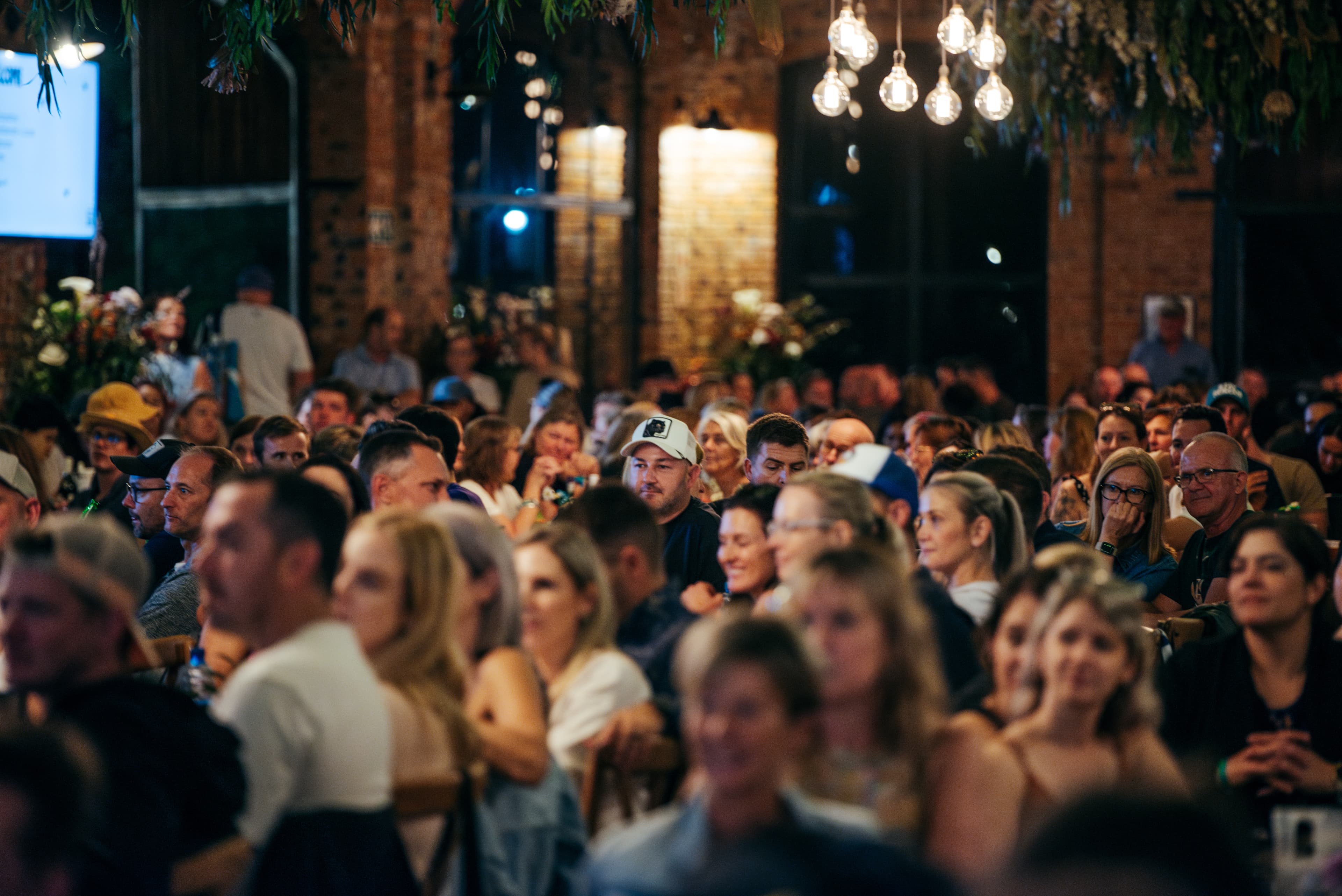 Race briefing at evening venue with crowd