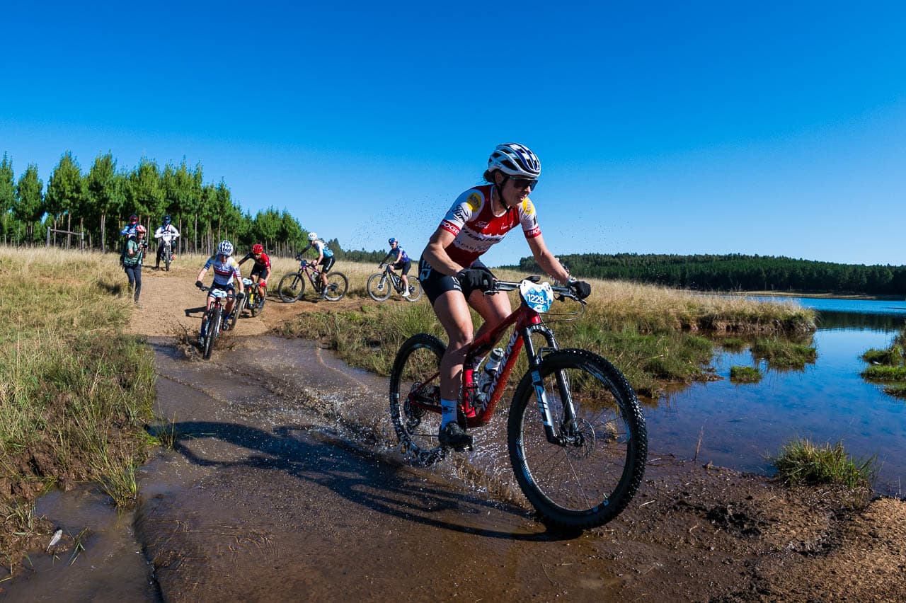 Rider splashing through water crossing