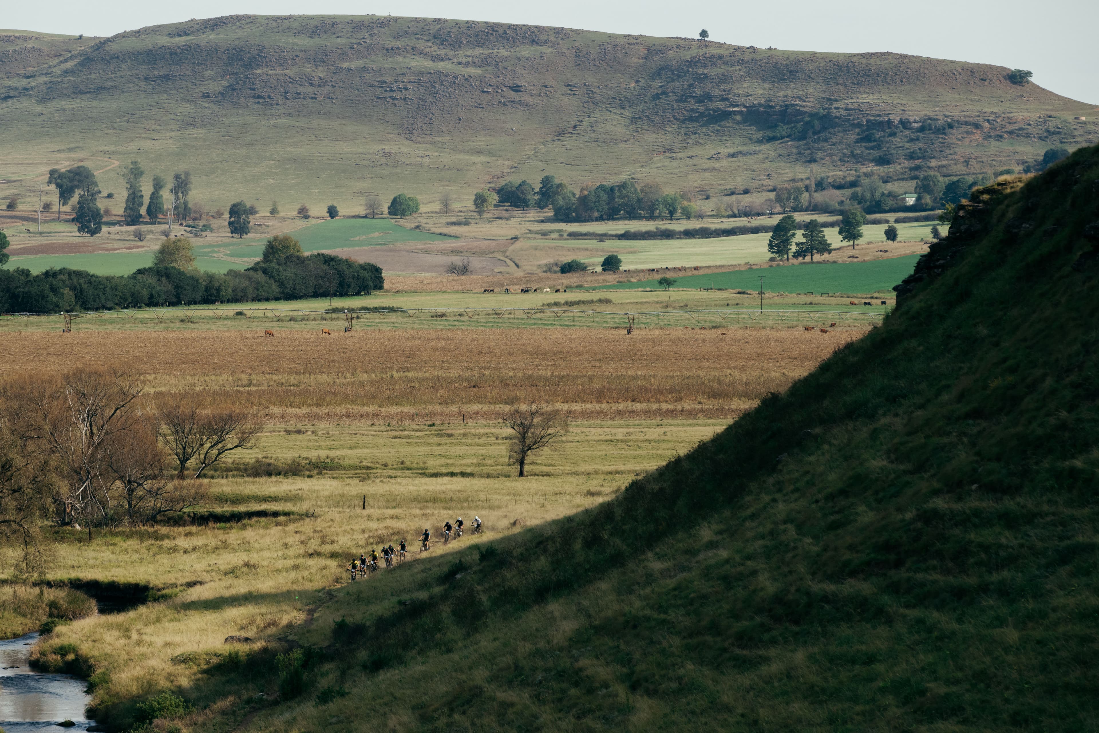 Riders in distant valley landscape
