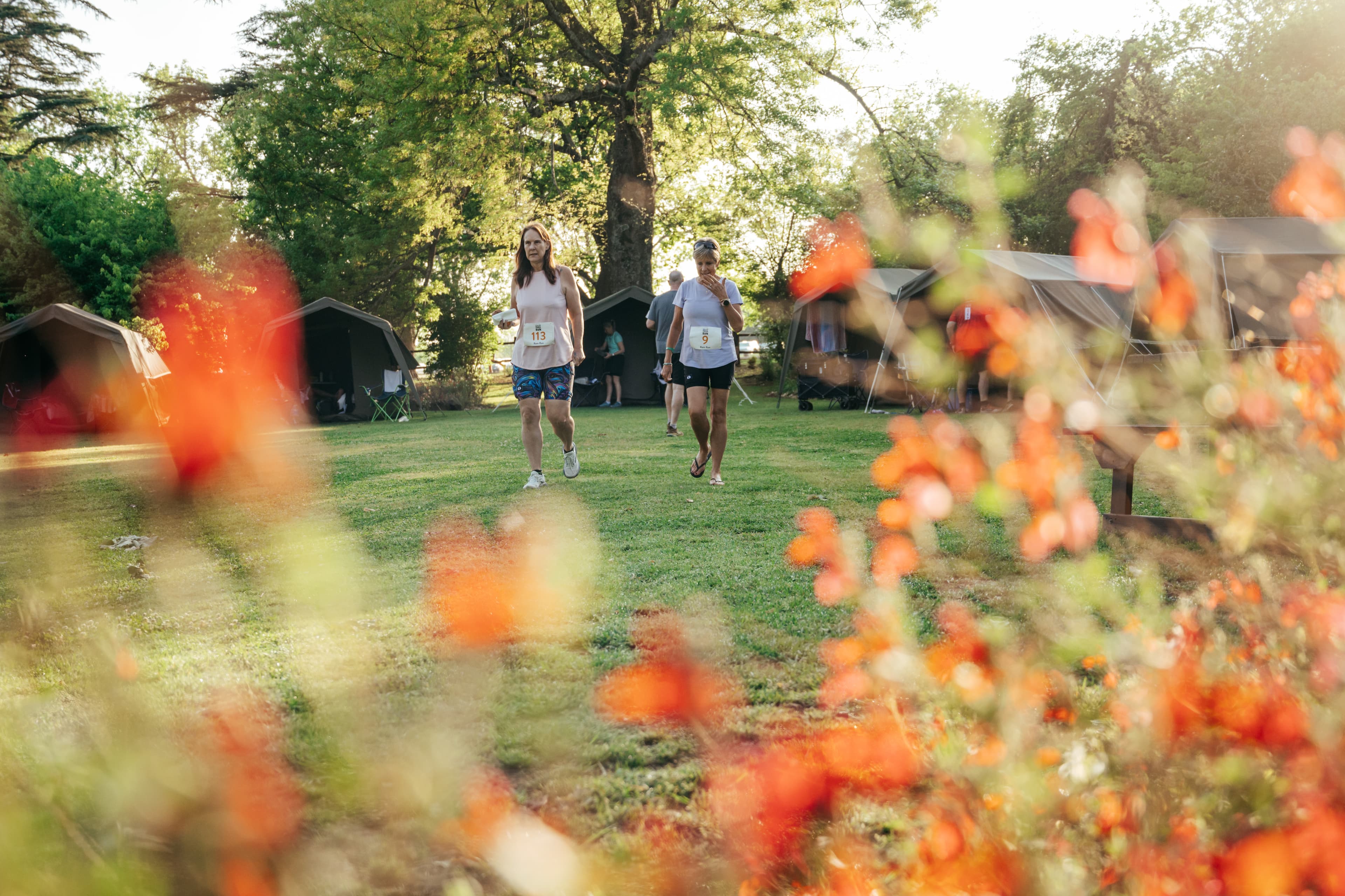 Walkers through flowers at race village
